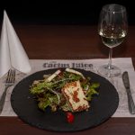 Grilled haloumi cheese with salads and fried seeds