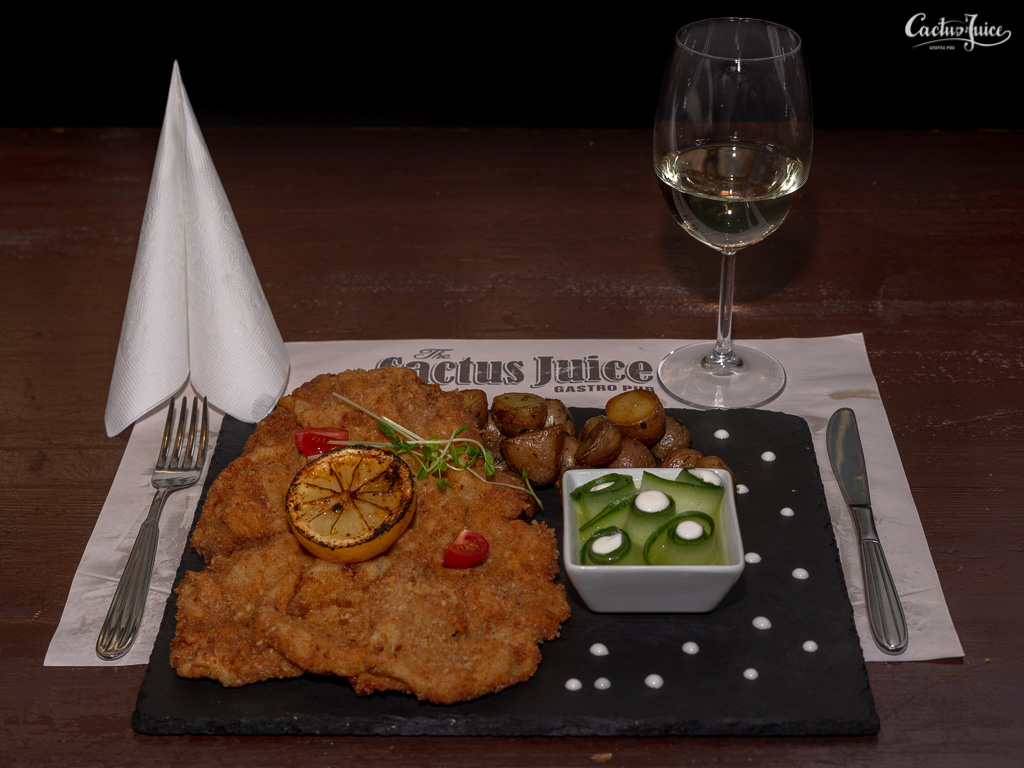 Wiener Schnitzel with parsley potatoes and cucumber salad with sour cream