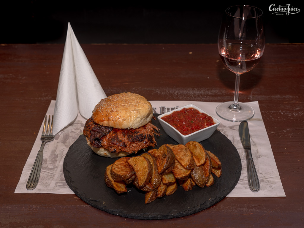 Pulled BBQ pork burger with salsa and fried potatoes
